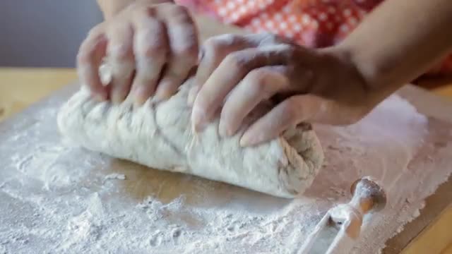 Hispanic woman kneading dough