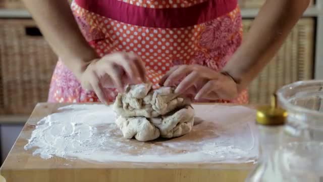 Hispanic woman kneading dough