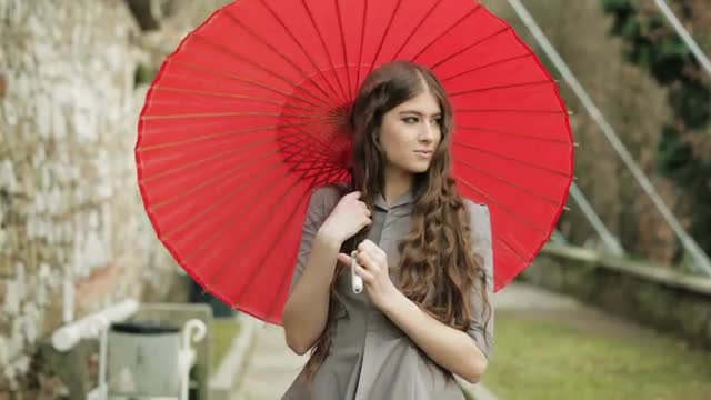 Elegant Fashion Model With Long Hair Poses With Traditional Japanese Umbrella