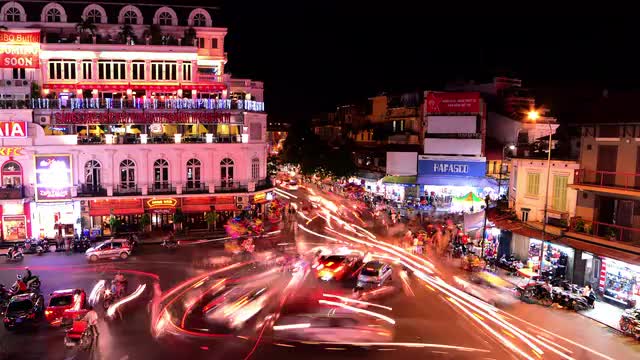 Time Lapse of Busy Downtown Traffic Circle at Night -  Hoan Kiem Lake / Hanoi Vietnam