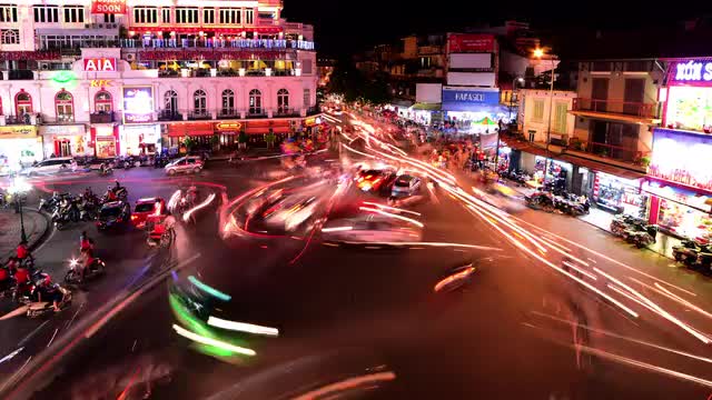 Time Lapse of Busy Downtown Traffic Circle at Night -  Hoan Kiem Lake / Hanoi Vietnam