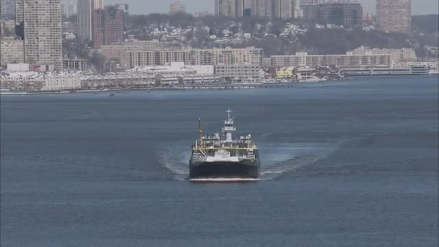 AERIAL WIDE view of a ship riding on the river