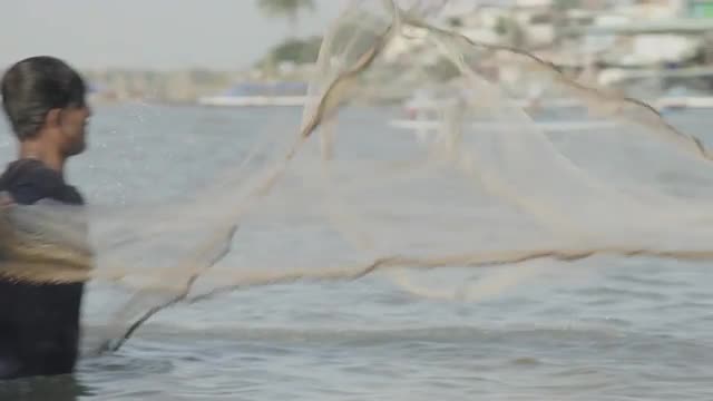 Casting a fishing net on the Mekong River, Can Tho, Vietnam.