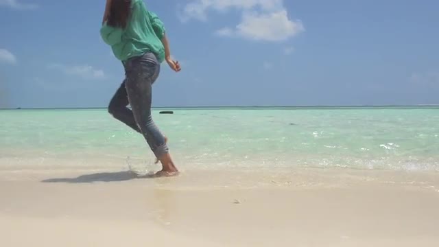 Young Tourist Runs Bare Feet Along White Sandy Beach