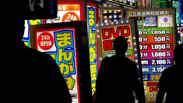 People Walking in Front of Japanese Advertisements -  Tokyo Japan