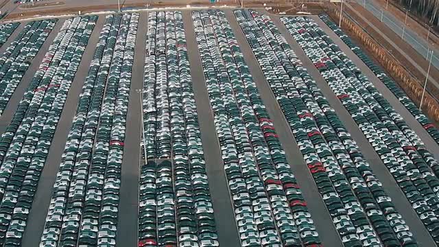 Flying Above Storage Parking Lot of New Unsold Cars, aerial view