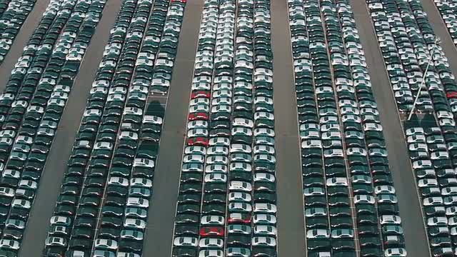 Flying Above Storage Parking Lot of New Unsold Cars, aerial view
