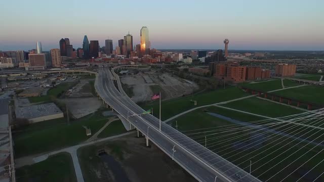 The United States Flag and The Margaret Hunt Hill Bridge over Singleton Boulevard in Downtown Dallas