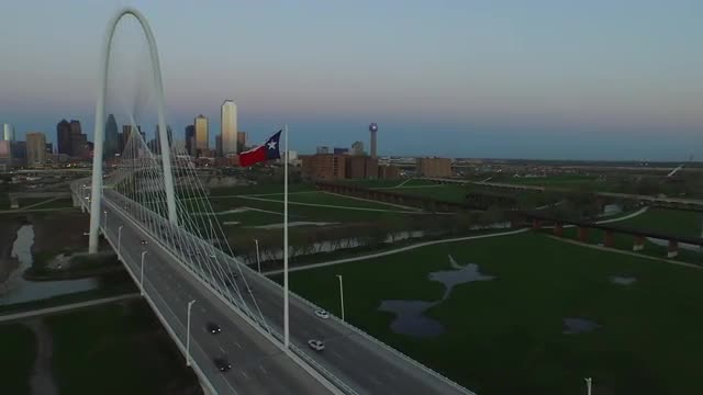 The Texas State Flag and The Margaret Hunt Hill Bridge over Singleton Boulevard in Downtown Dallas