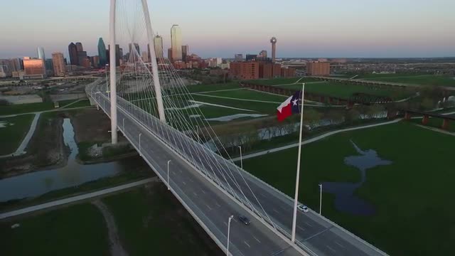 The Texas State Flag and The Margaret Hunt Hill Bridge over Singleton Boulevard in Downtown Dallas