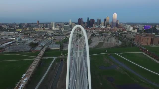 The Texas State and United States Flags flying over The Margaret Hunt Hill Bridge in Downtown Dallas