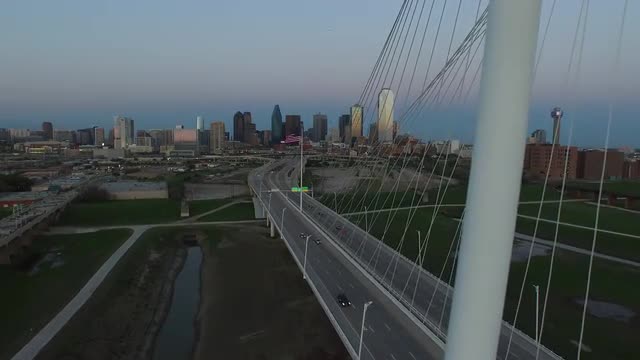 The Texas State and United States Flags flying over The Margaret Hunt Hill Bridge in Downtown Dallas