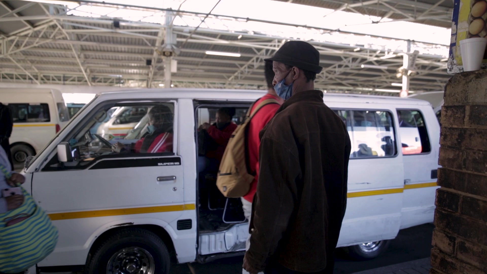 Taxi Marshall directing passenger to another taxi