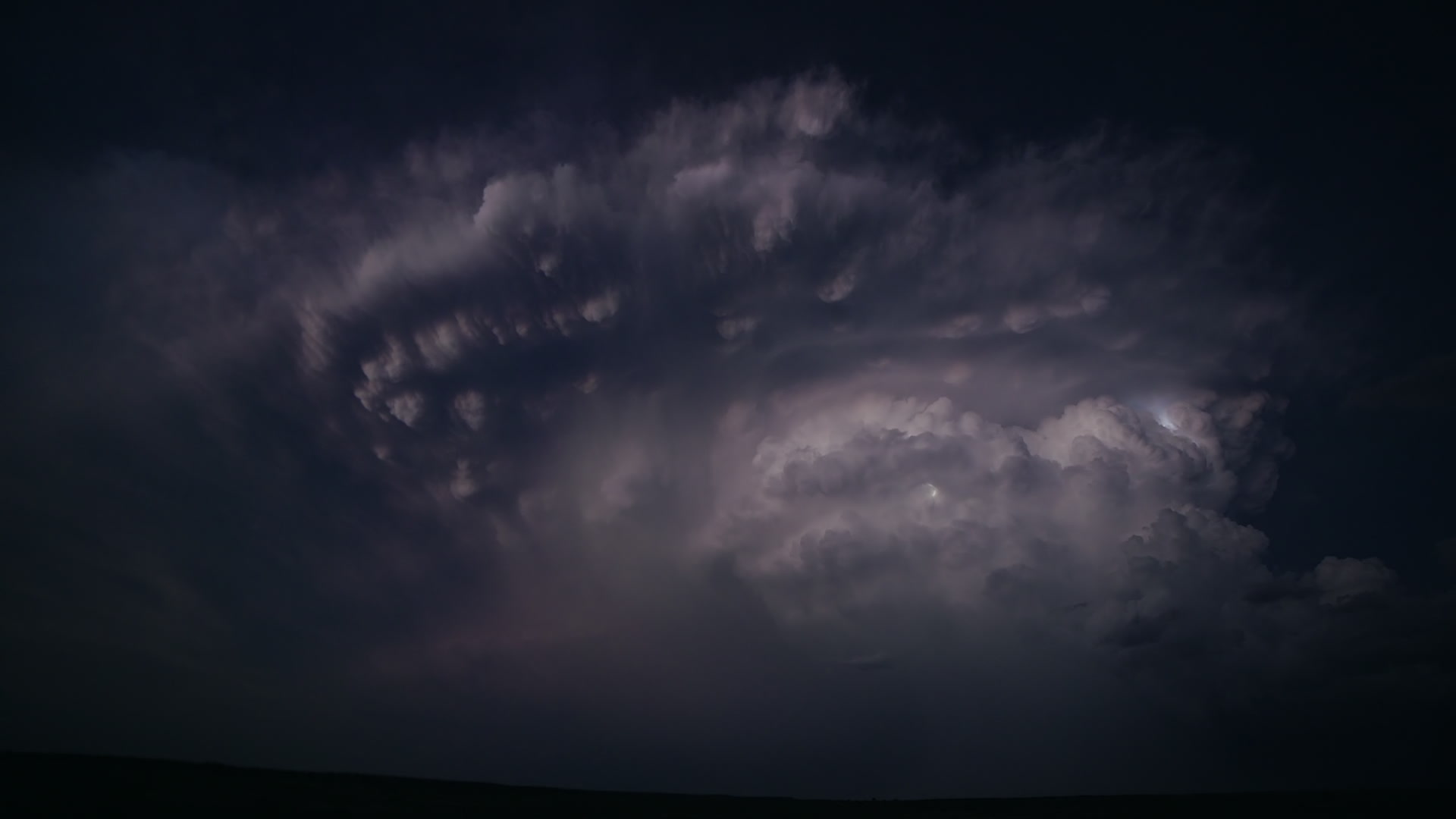 Continuous lightning, supercell at dusk