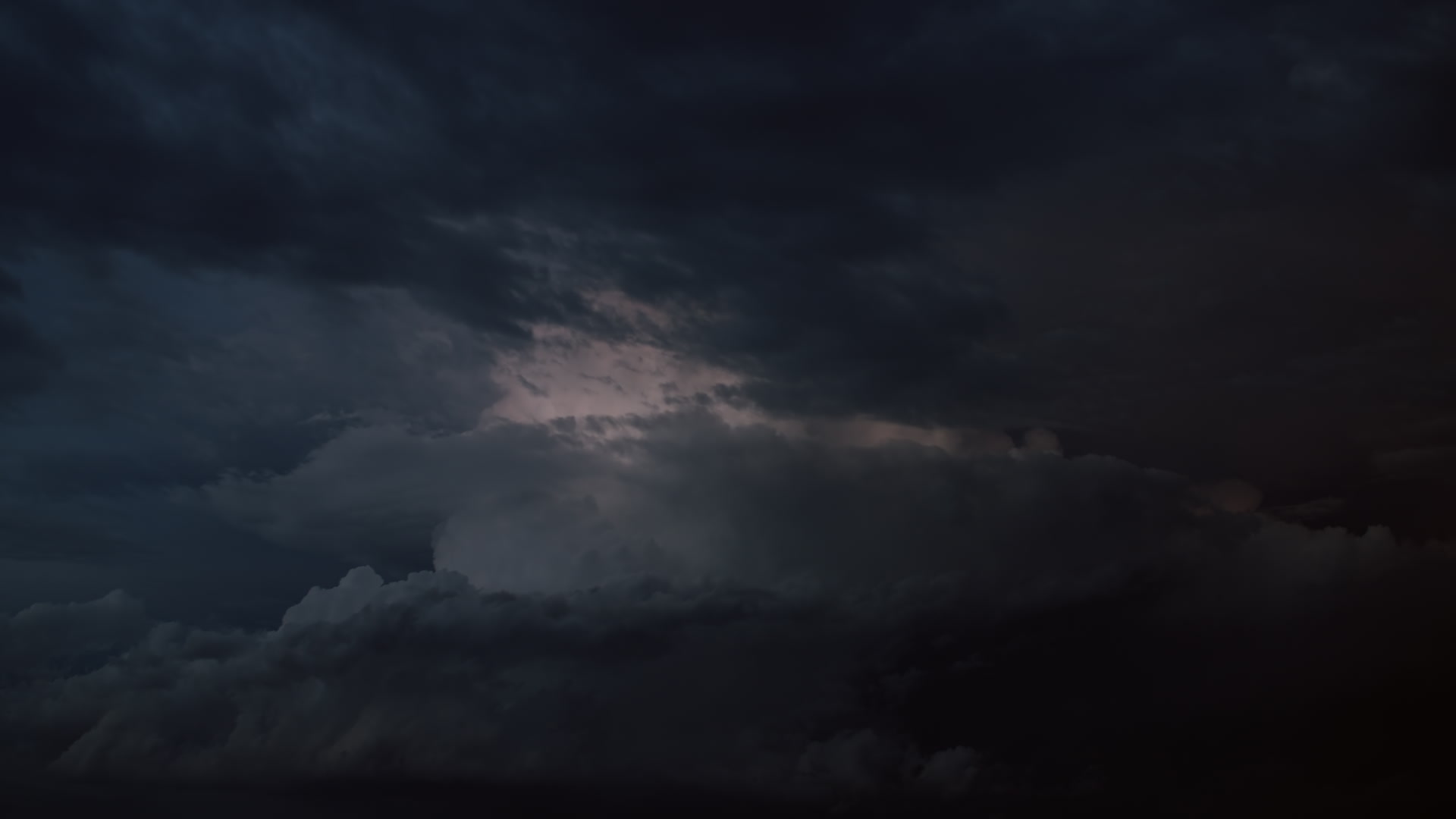 Lightning-filled supercell thunderstorm spins at dusk