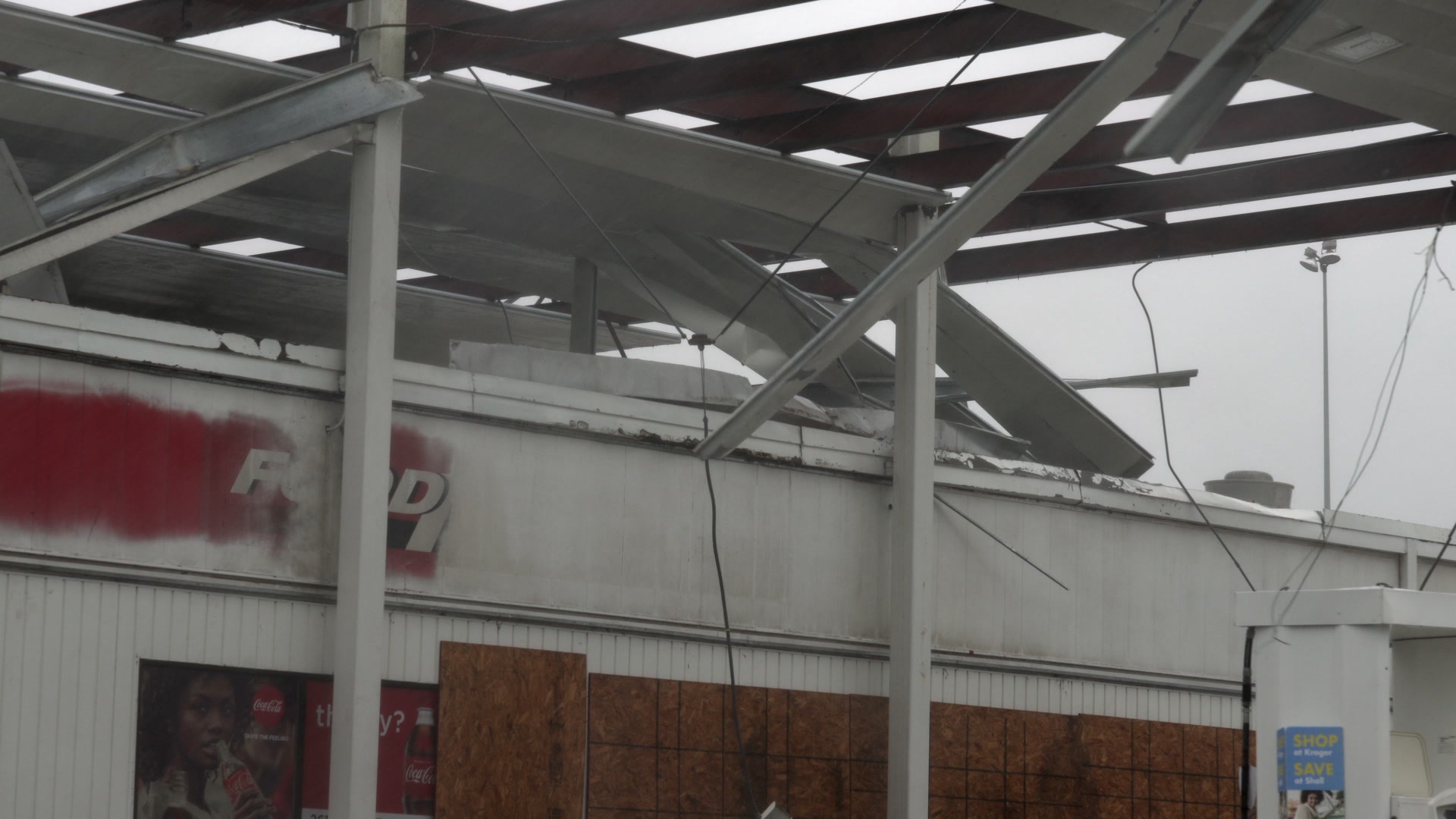 Hurricane Delta - Shredded sheet metal blows in wind, damaged gas station, 4K
