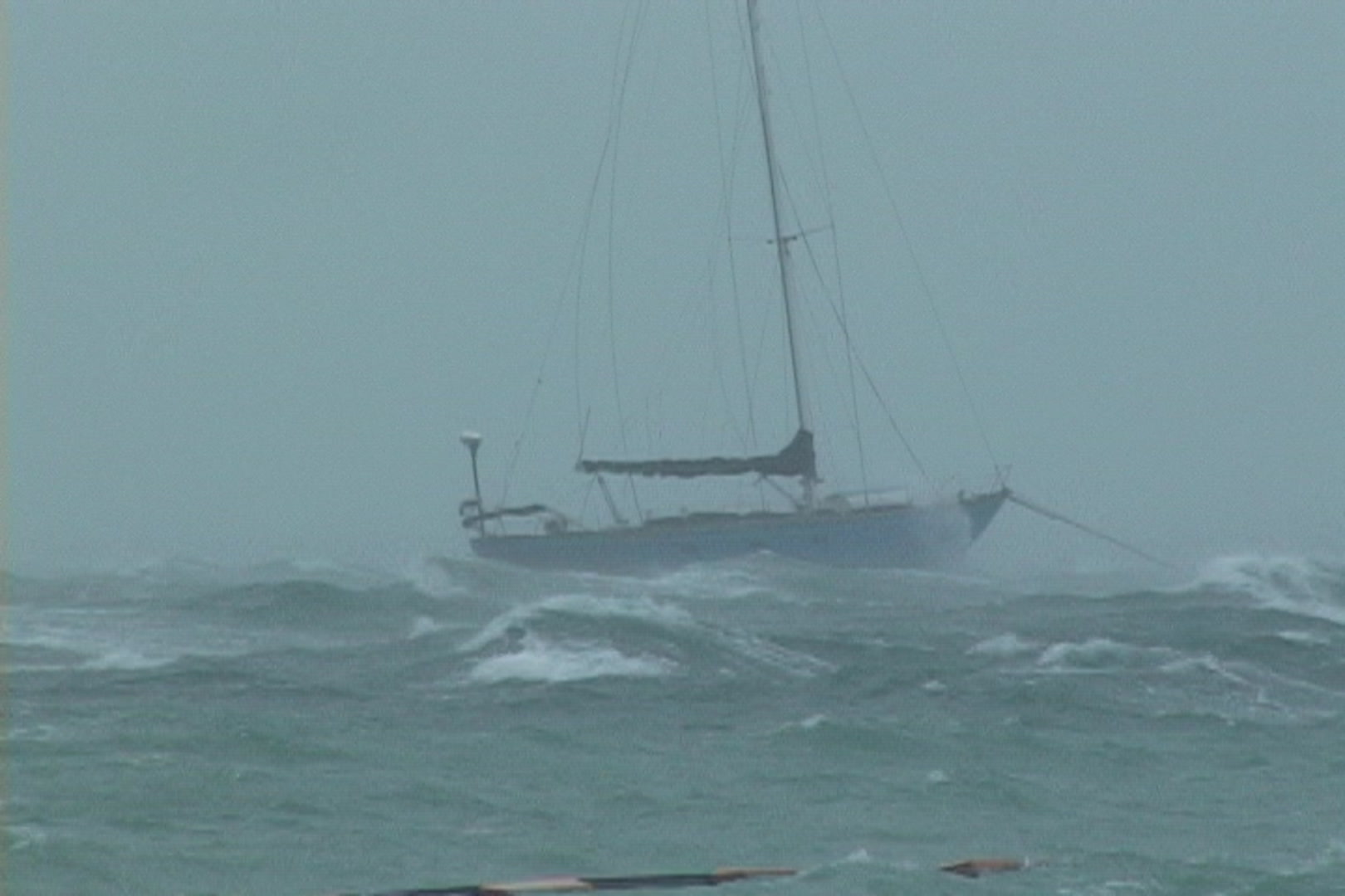 Intense hurricane - sailboat anchored in hurricane waves