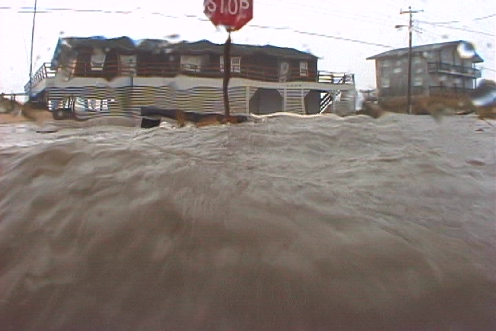 Intense hurricane - Storm surge strikes camera, coastal town