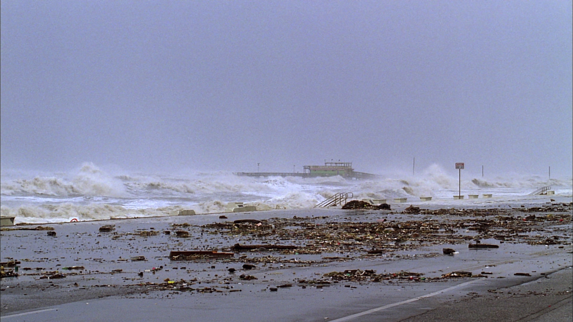 Powerful Hurricane Ike, 35mm film to 4K - huge waves crash against sea wall, pier in distance