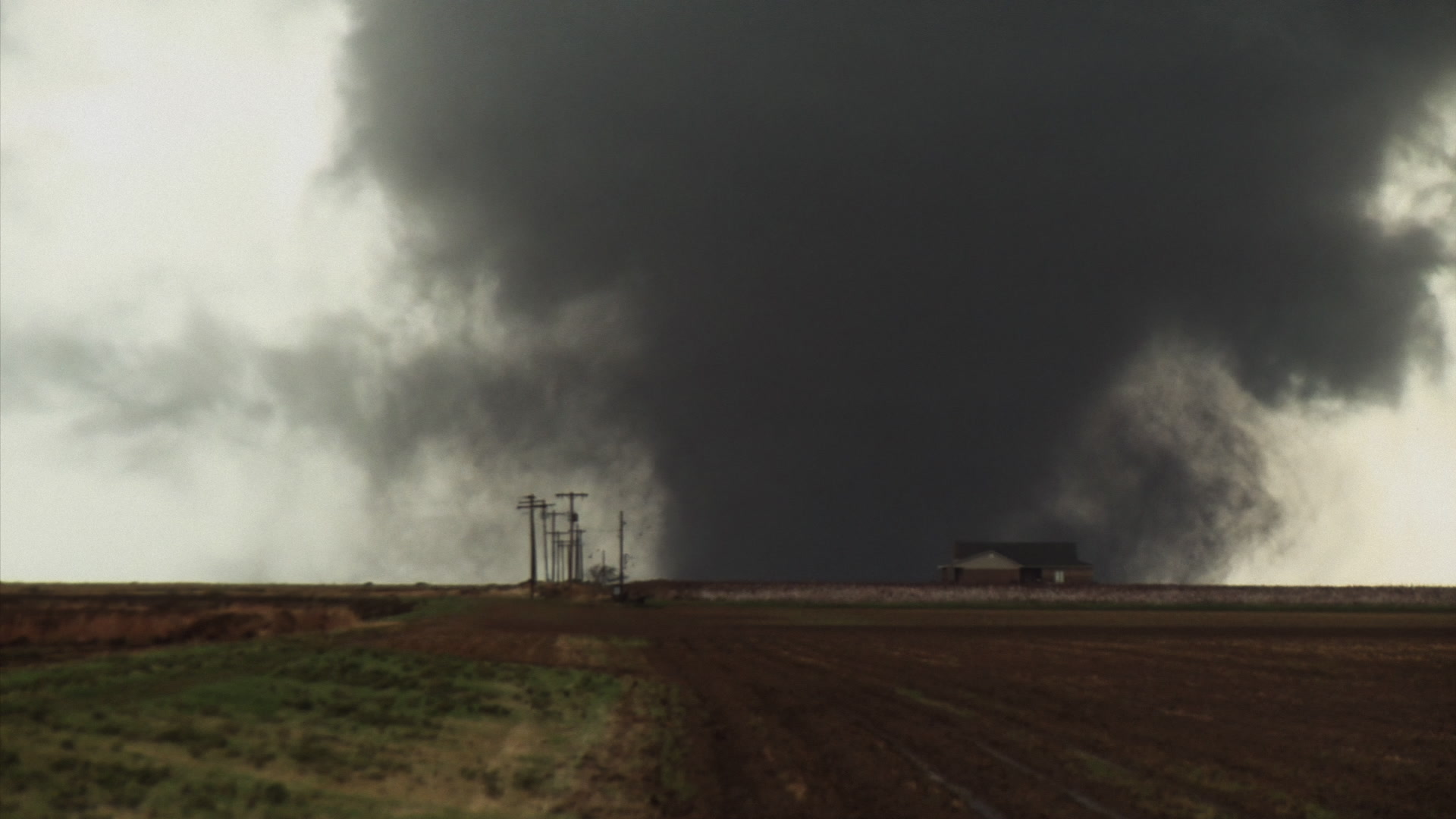 Oklahoma Tornado - Large wedge tornado passes behind house, lightning