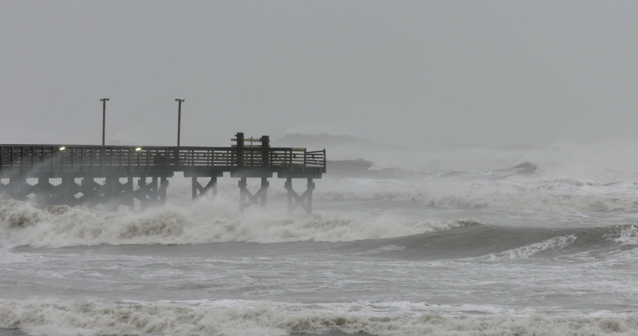 Hurricane Delta - Waves crash into wooden pier
