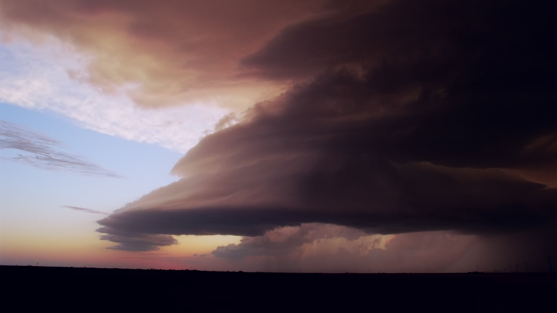 Storms on 35 - Orange supercell and lightning, dusk, Texas