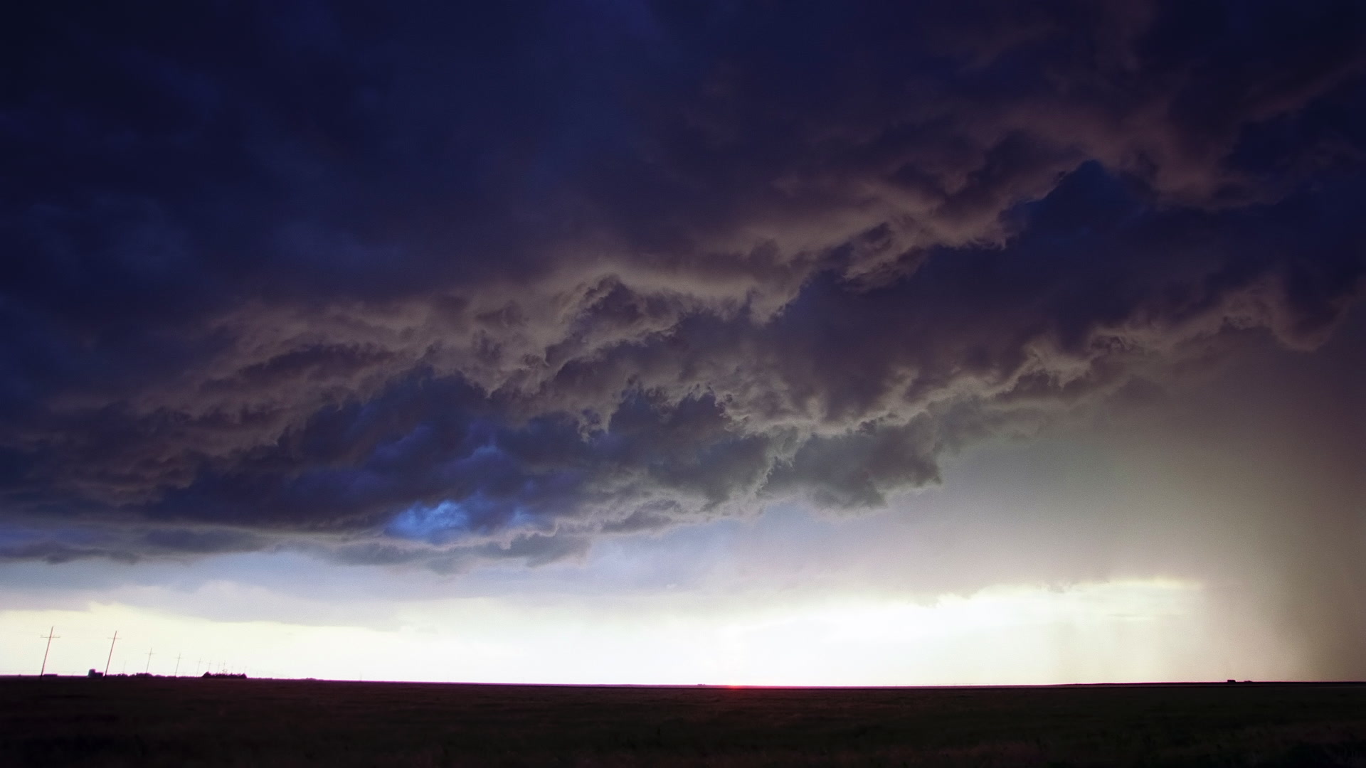 Storms on 35 - Amazing, inky storm clouds swirl above prairie at sunset, Texas