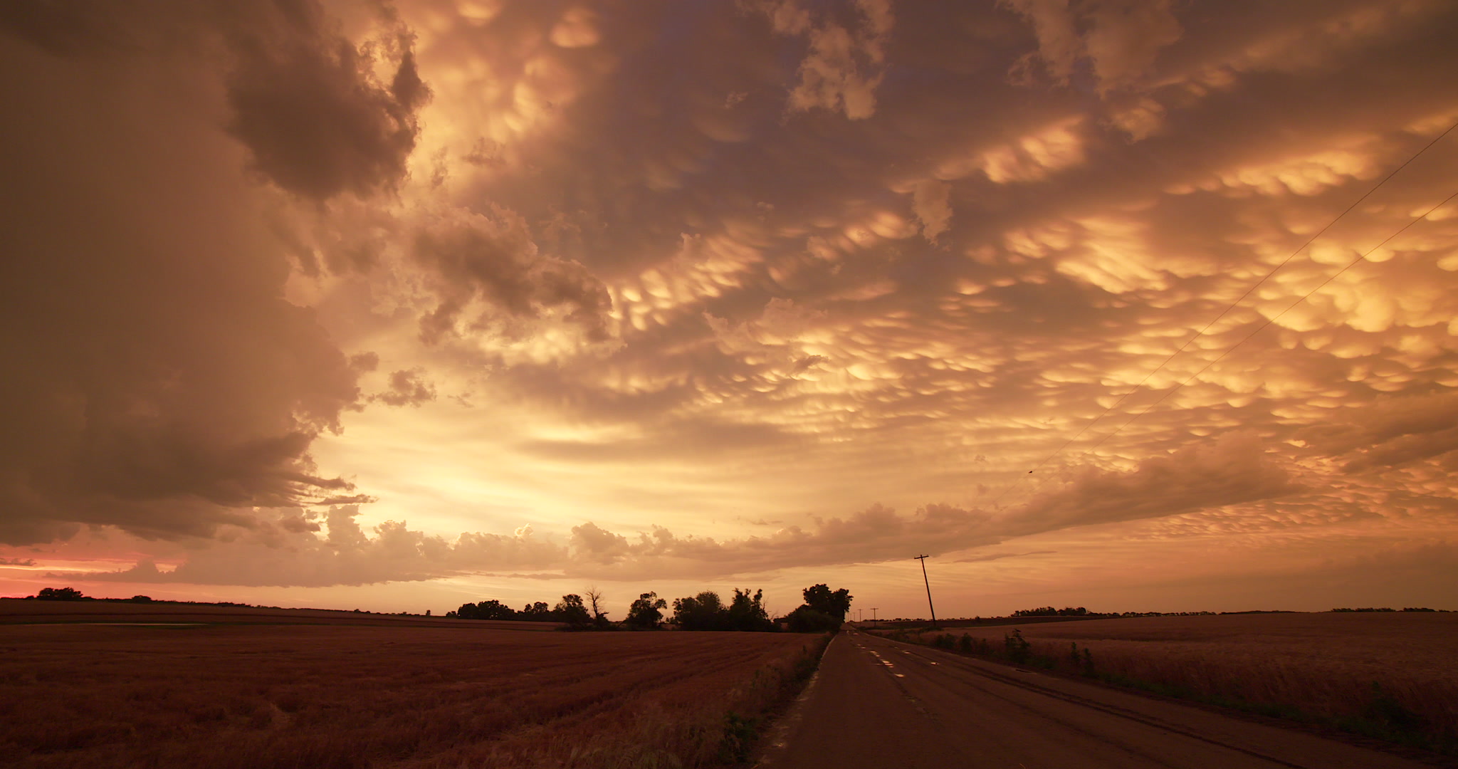 Beautiful mammatus clouds at sunset, pan left, Kansas, 4K