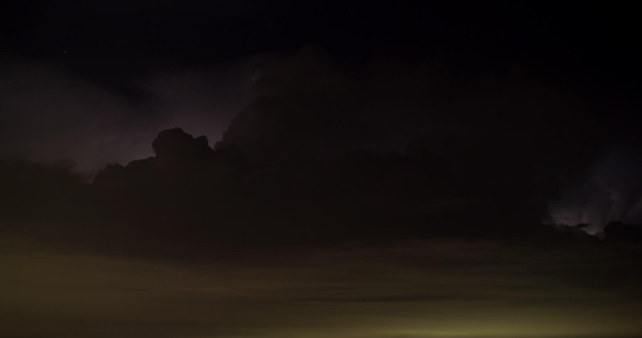 Storm clouds - Constant lightning flashes in storm at night, urban glow below, time-lapse, 4K