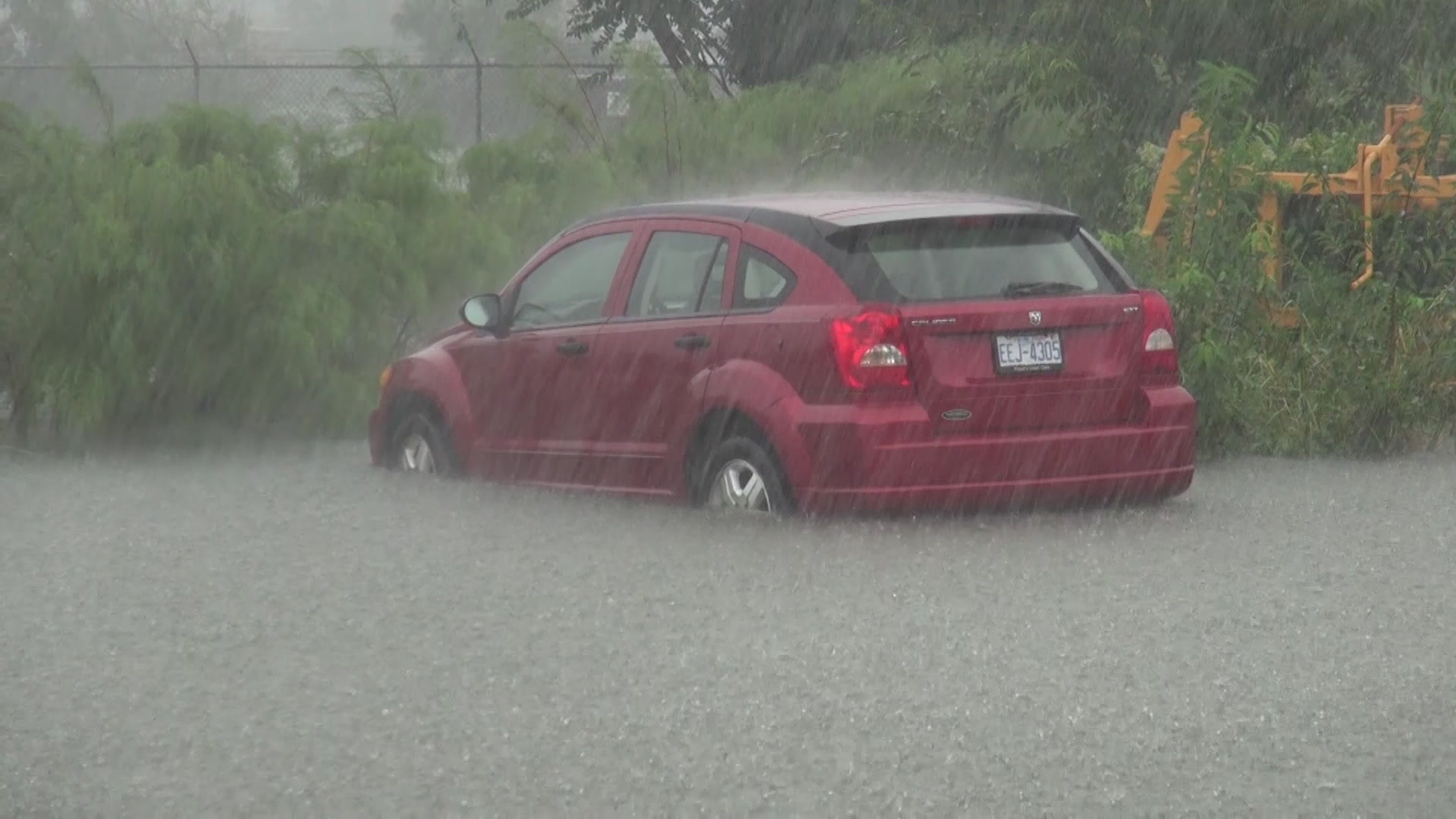 Heavy rain falls on car stranded in flooded parking lot, Hurricane Florence, 2018