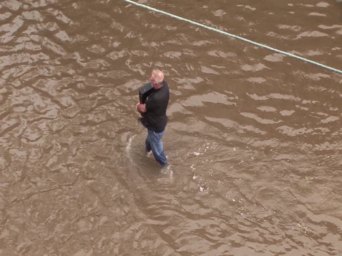 Powerful Hurricane Ike, Galveston, 2008 - Man carries computer down flooded street