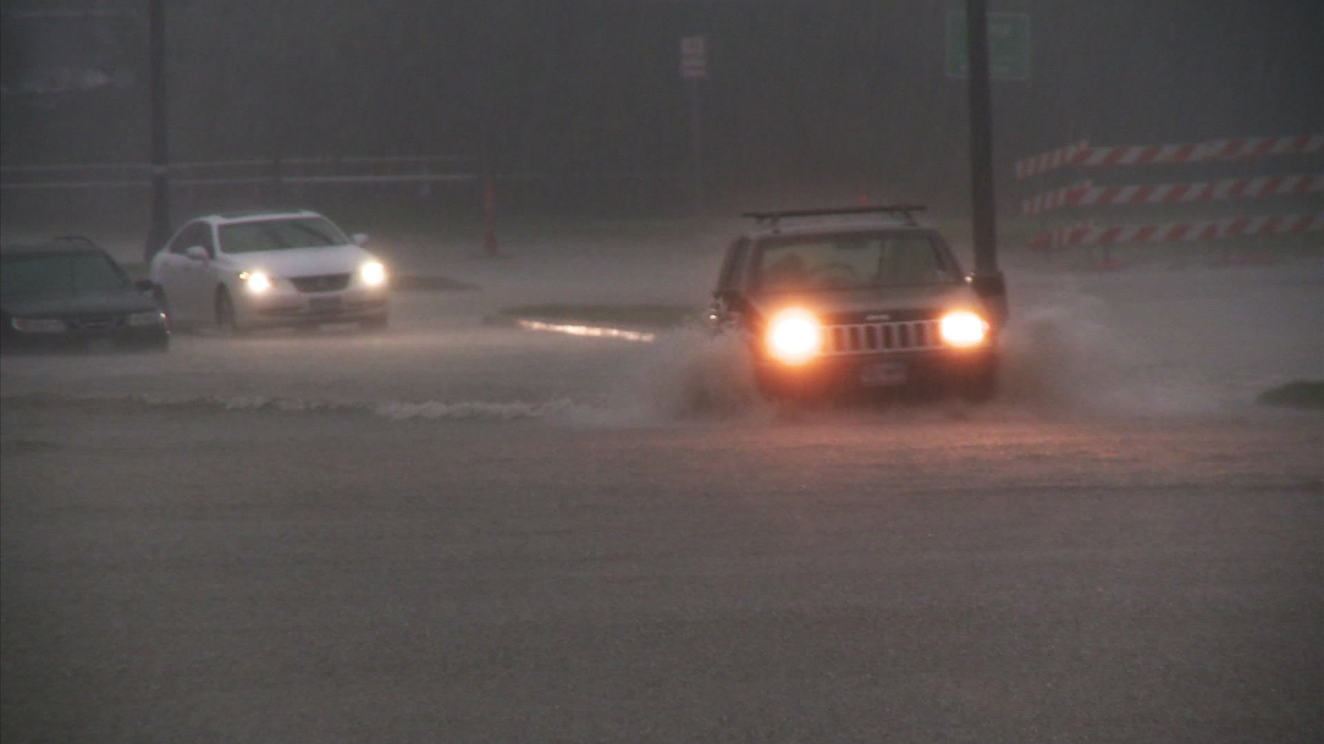 Urban flooding - Jeep drives through flooded street