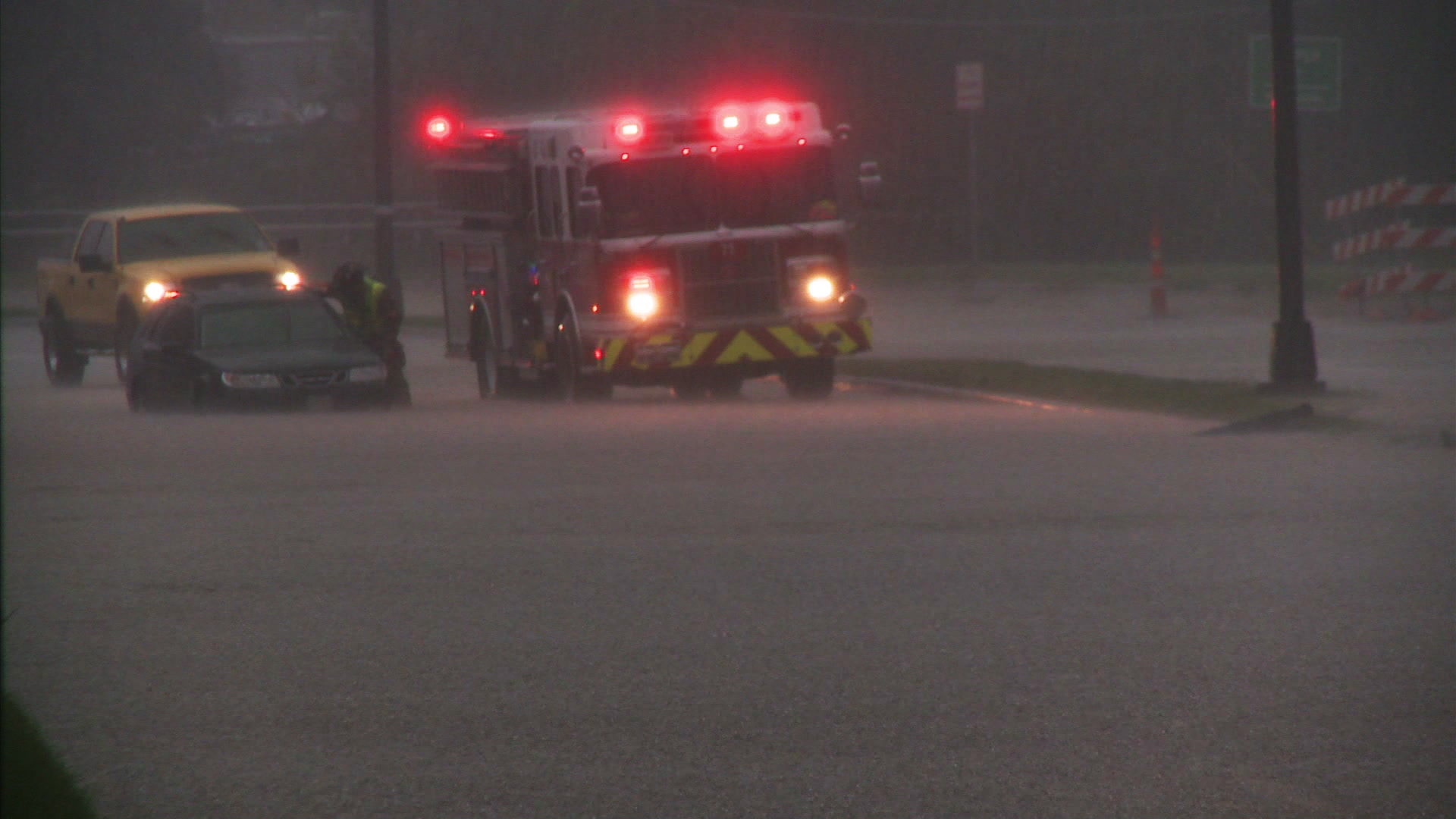 Urban flooding - Fire truck and car stalled on flooded street