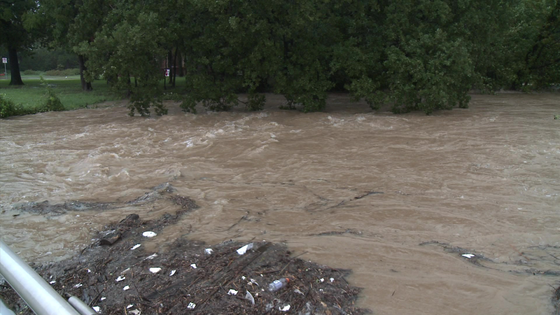 Urban flooding - Swirling flood water shot from bridge