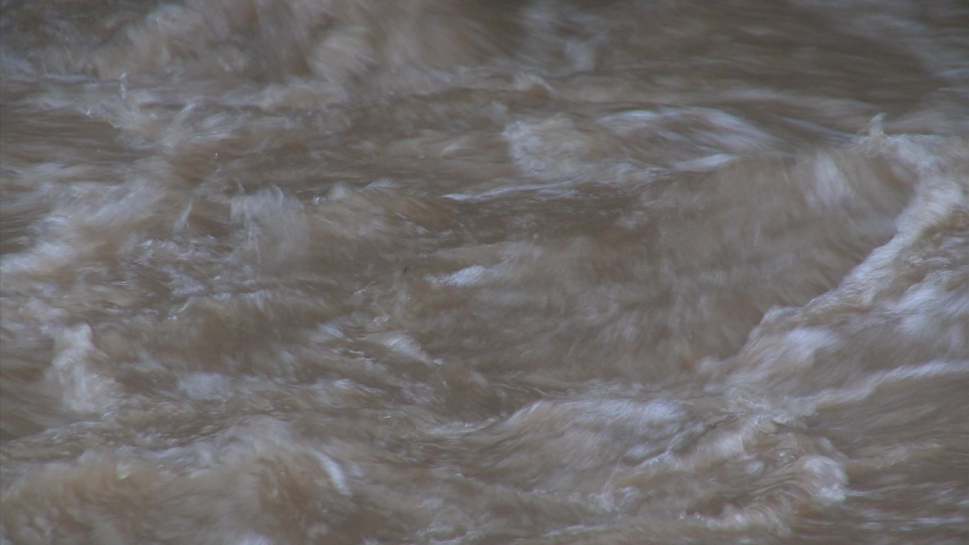 Urban flooding - Close-up of rushing flood water