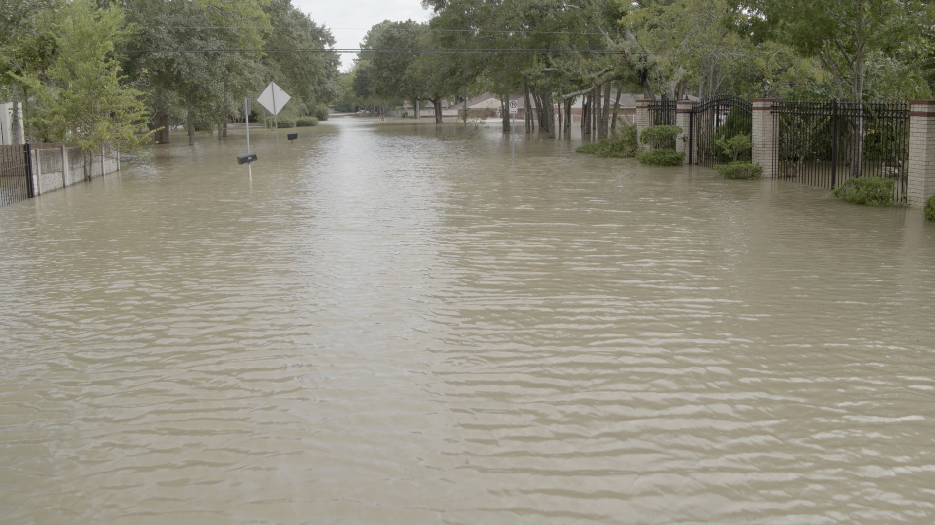 Hurricane Harvey - Low aerial shot of flooded residential street, 4K