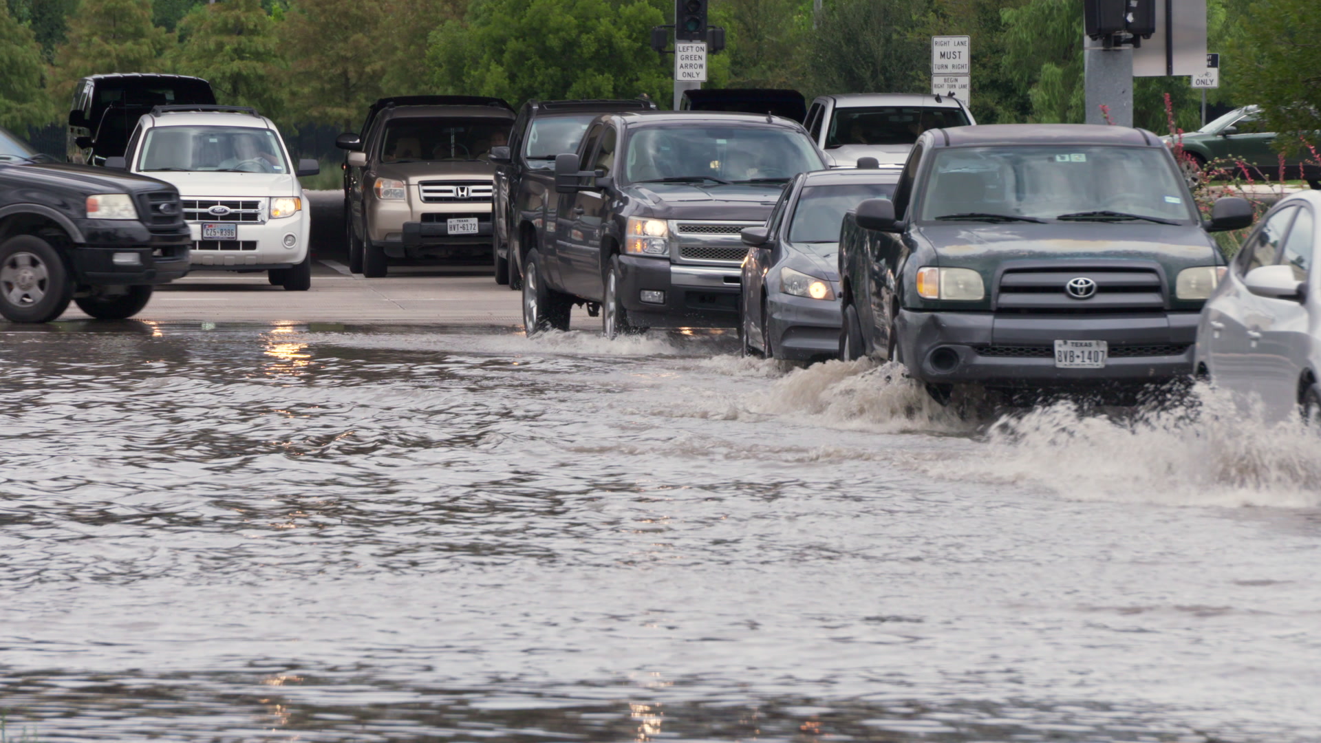 Hurricane Harvey - Traffic drives across flooded road, 4K