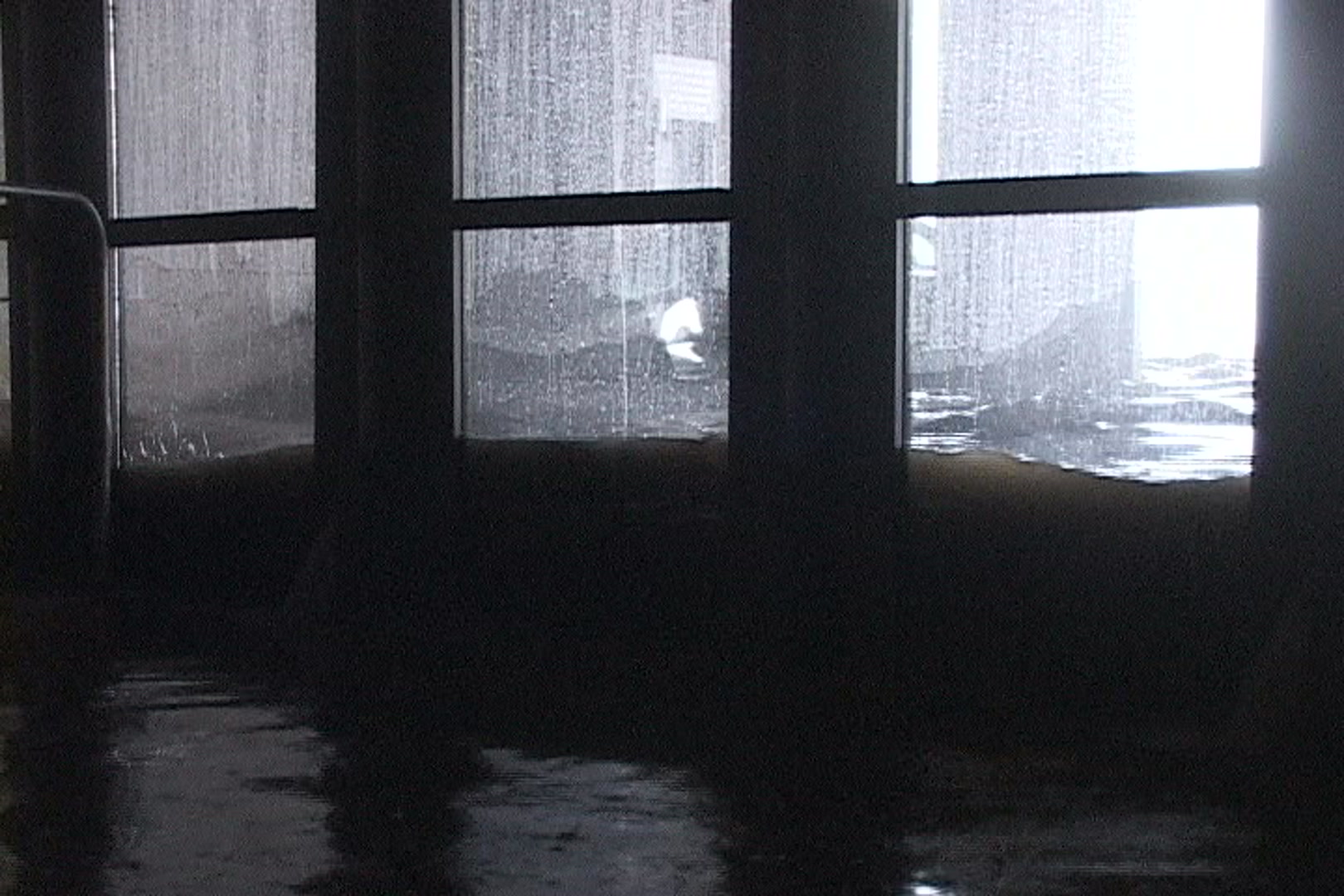 Dramatic shot of waves against doors and car floating by, Hurricane Katrina