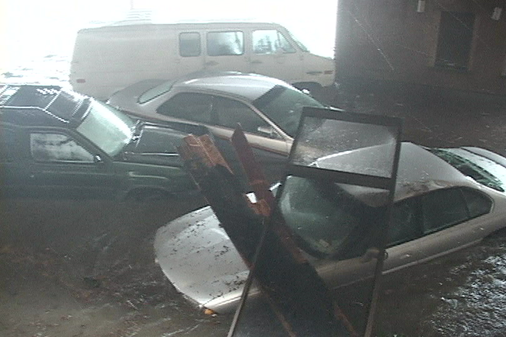 Cars, van piled up by storm surge, Hurricane Katrina