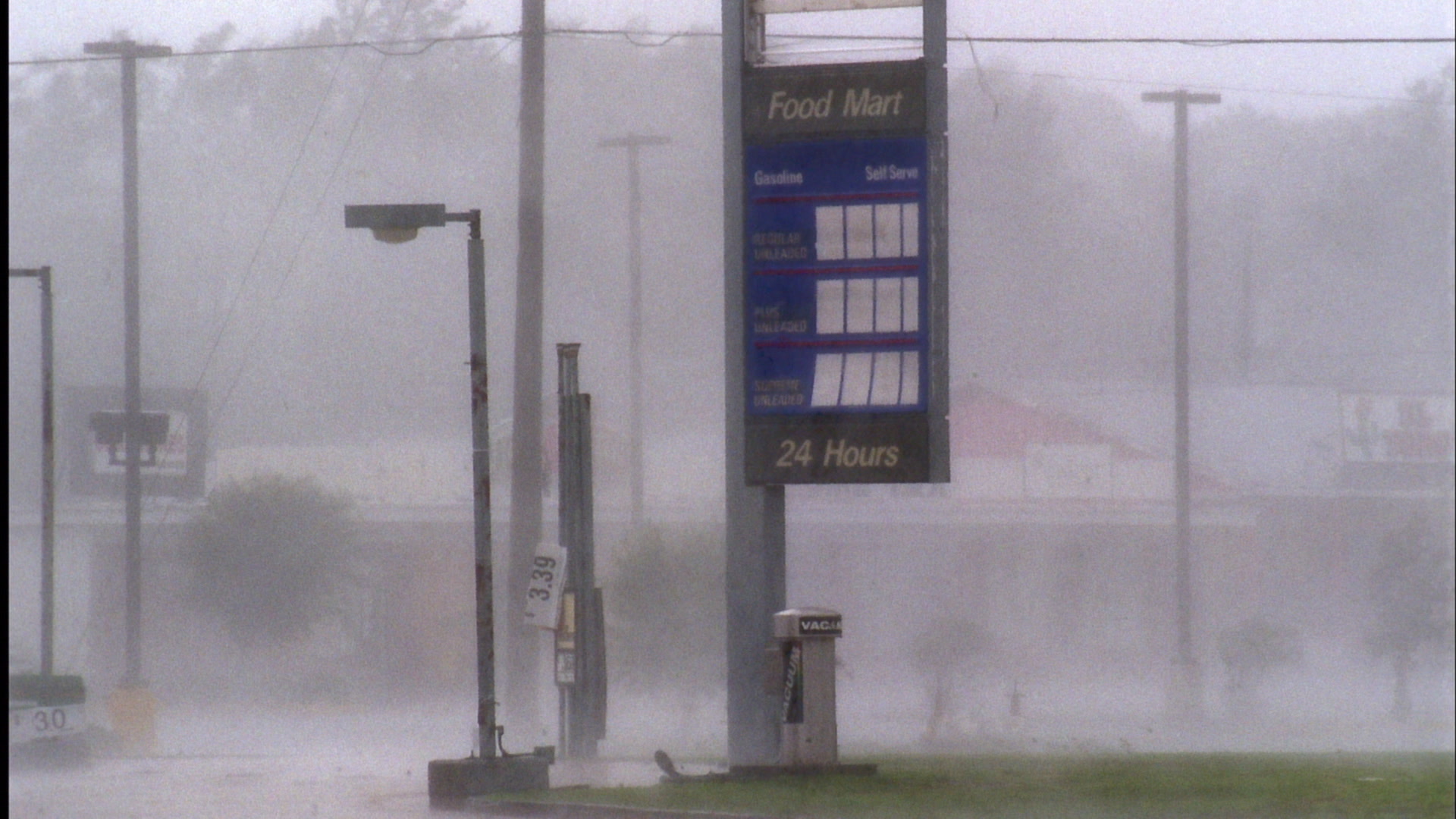 Wind, rain, flying debris blow past food mart sign, Hurricane Katrina, film, HD