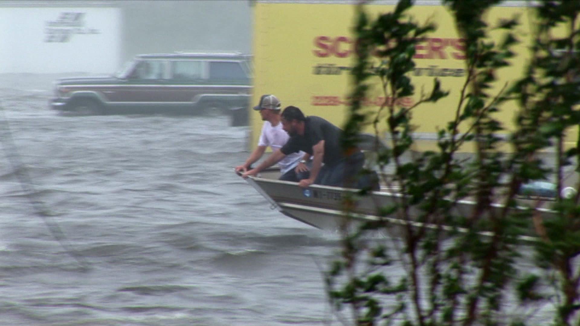 Residents search for flood victims from boat, Hurricane Katrina, 4K