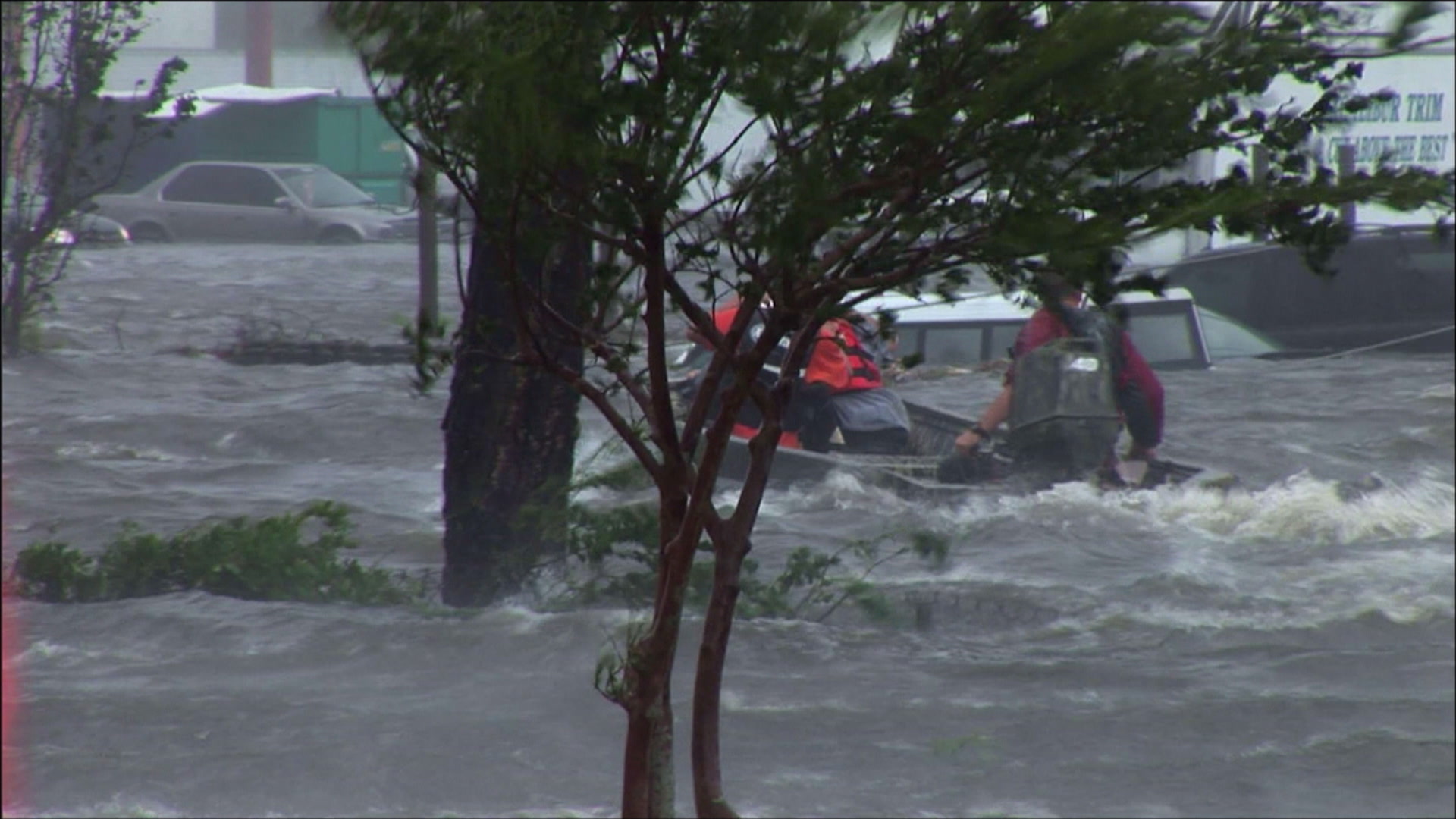 High water rescue team passes behind trees, intense, wind, surge, Hurricane Katrina, 4K