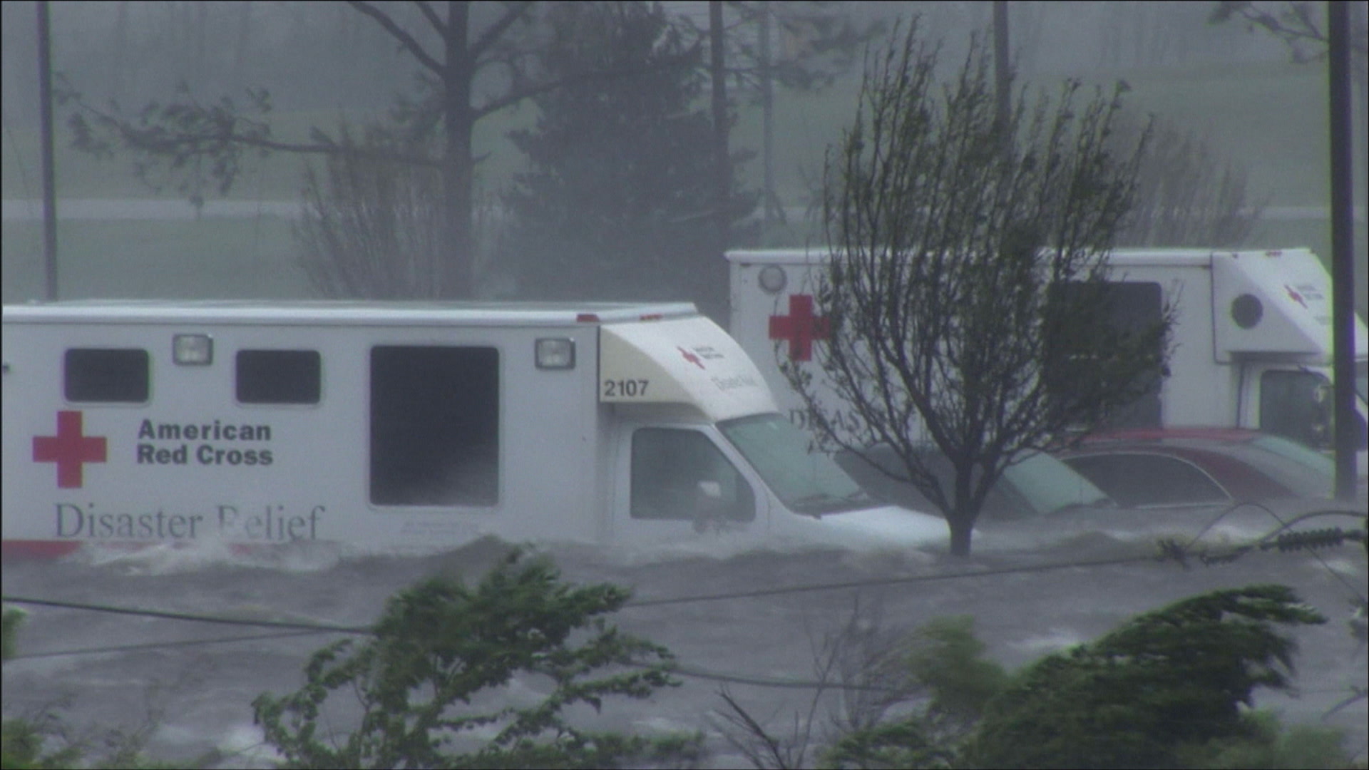 Dramatic panning shot of parking lot, cars, hotel, caught in storm surge, Hurricane Katrina, 4K