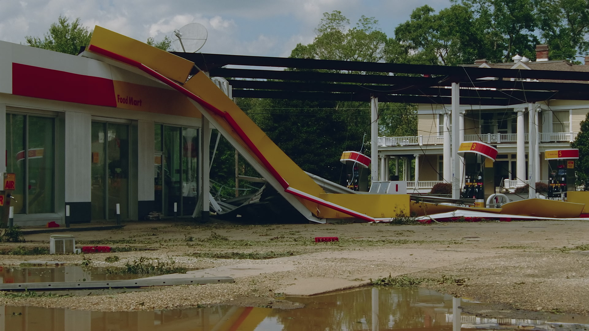 Wide shot of damaged gas station and house, Hurricane Katrina, 35mm to 4K