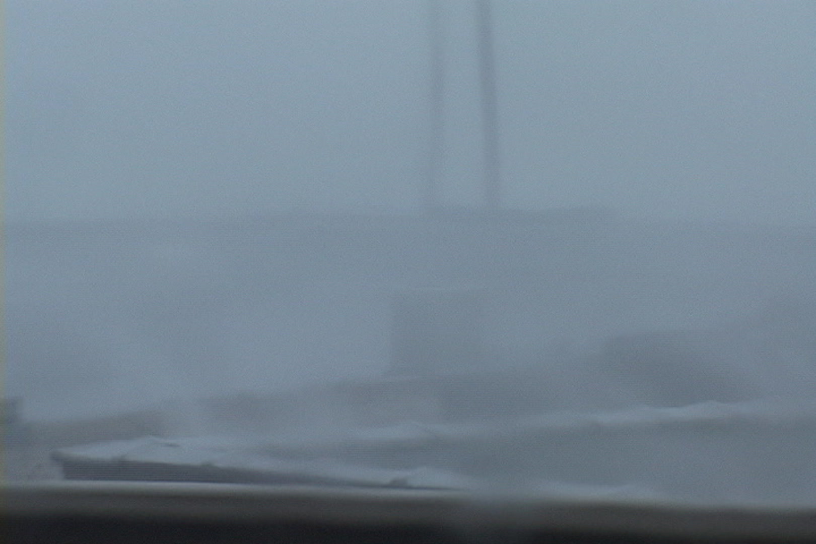 Intense wind and rain blow across rooftop during Hurricane Katrina