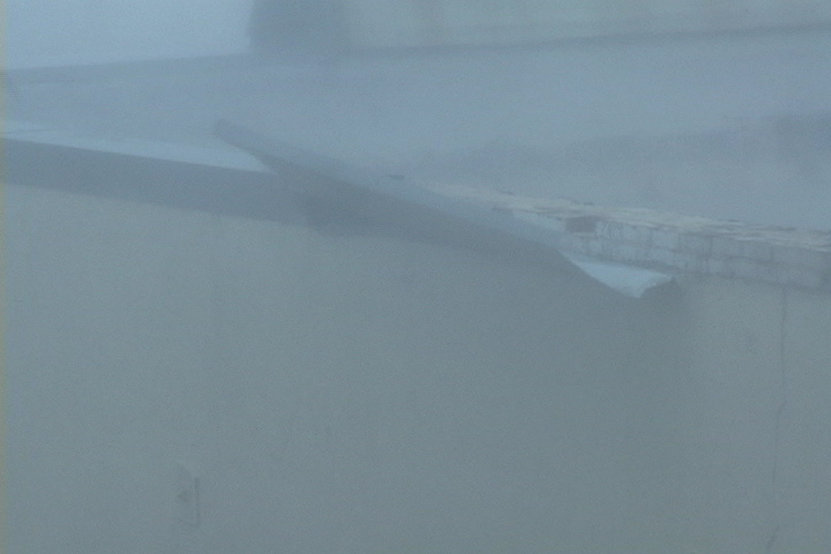 Roofing starting to come off building during Hurricane Katrina