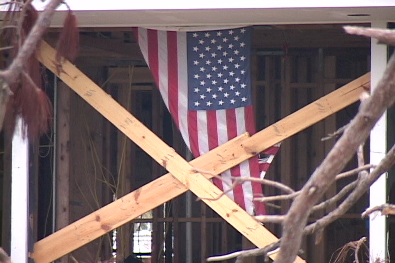 American flag hangs in damaged home, Hurricane Katrina