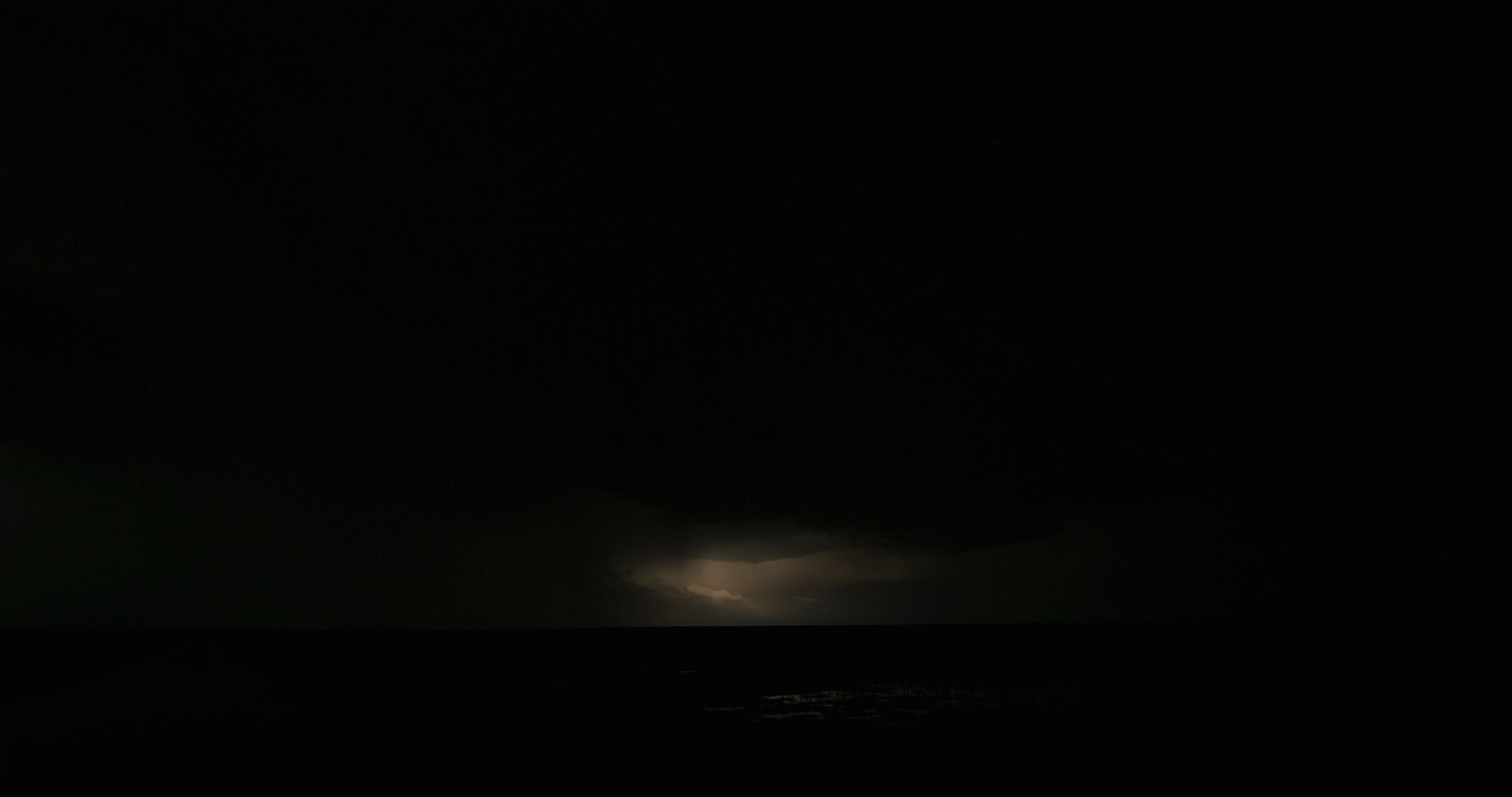 Big lightning flashes, thunderstorm, over wet farm field at night, Kansas, 4K