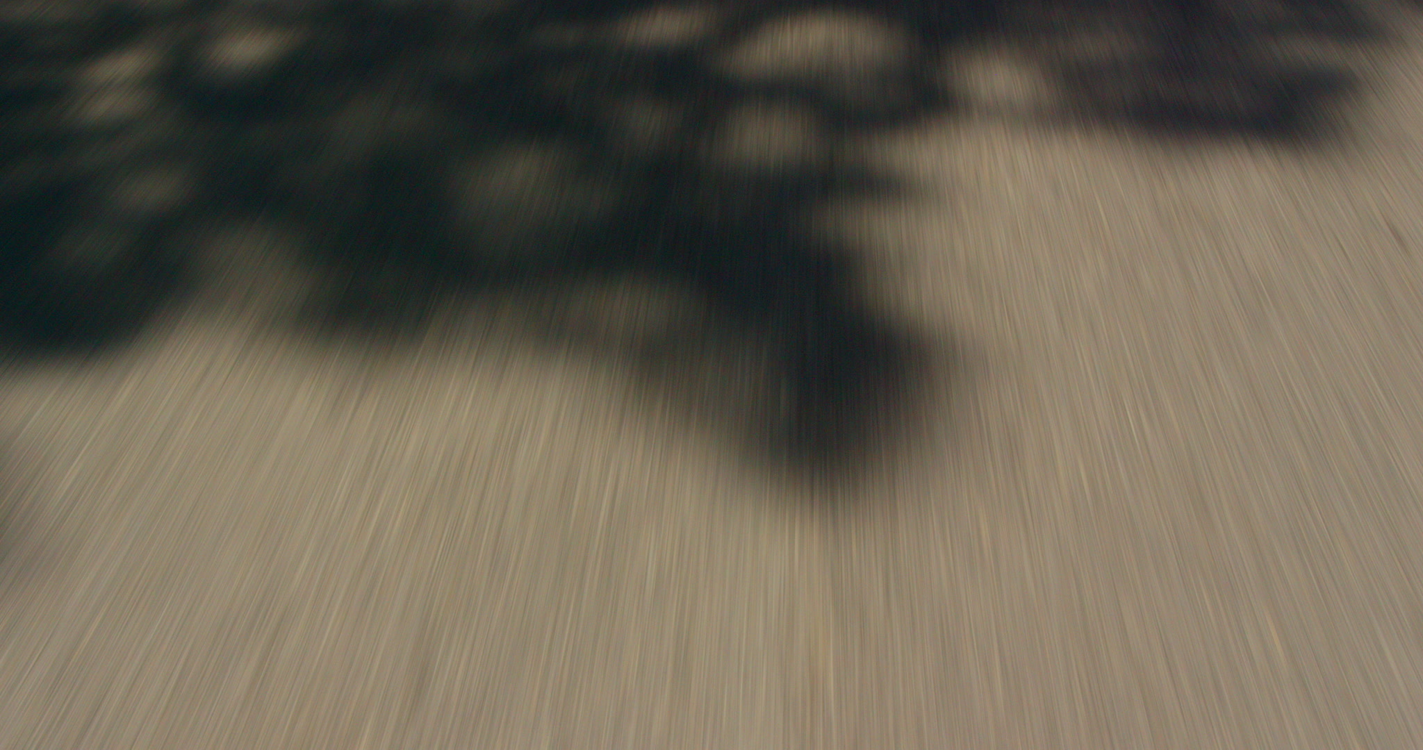 Car POV of yellow road stripes going by, down shot, 4K