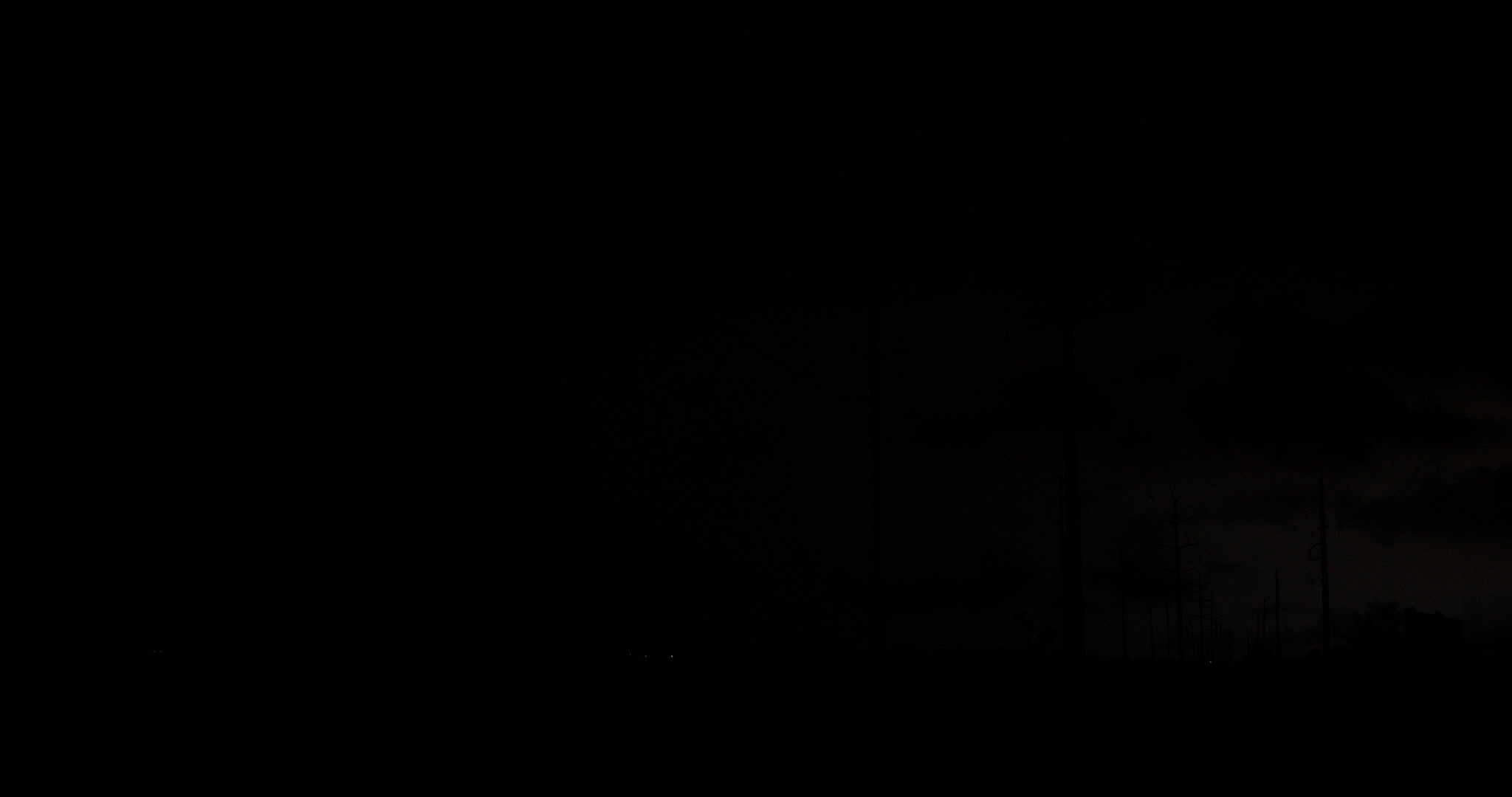 Lightning bolts strike behind power lines, night, Texas, 4K